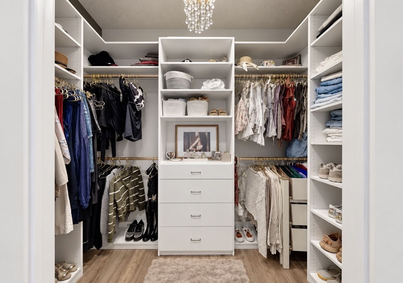 White built-in walk-in closet with chandelier