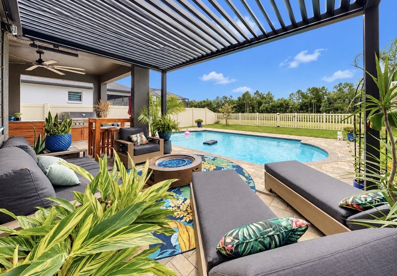 Pergola lounge with fire pit beside the saltwater pool